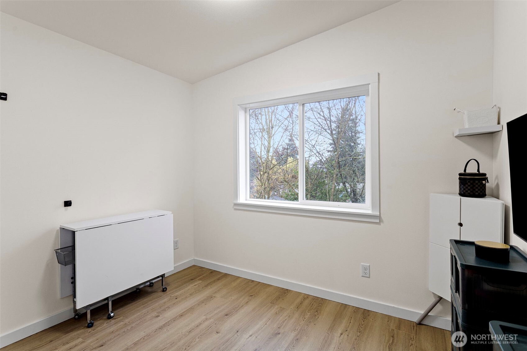 10615 2nd Place Southwest Seattle, WA 98146 - Photo 23 of 28 a view of an empty room with wooden floor and a window