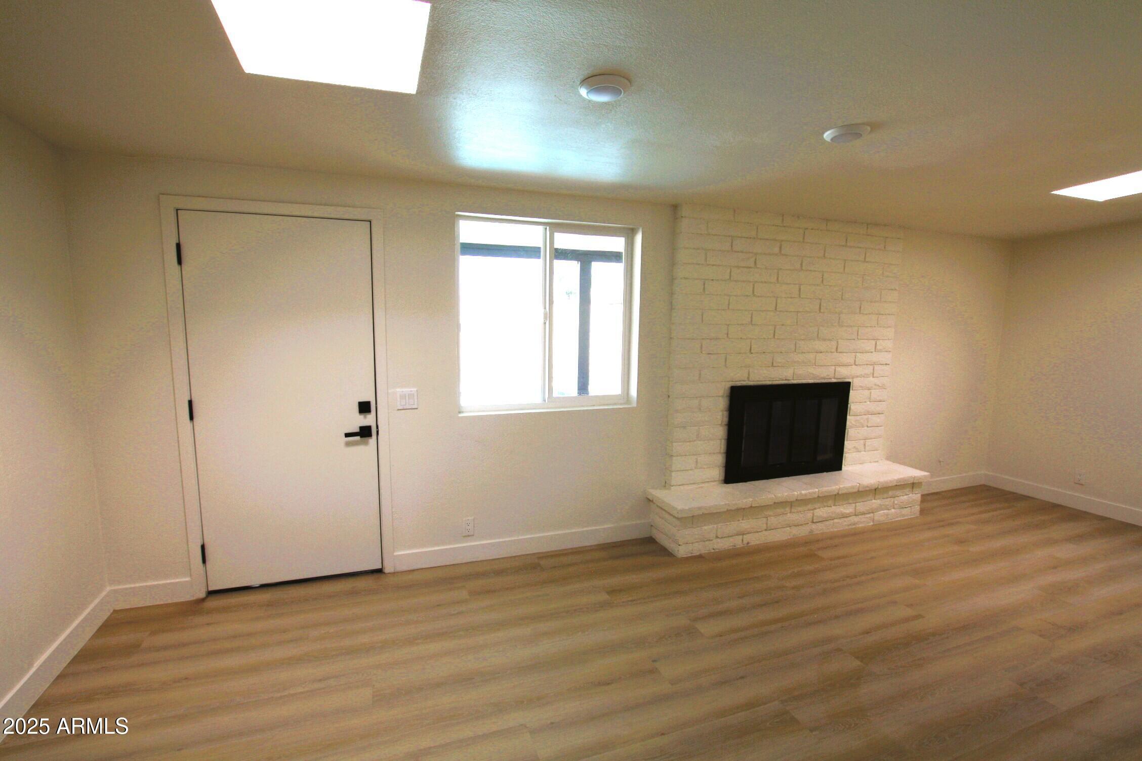443 North Sycamore Mesa, AZ 85201 - Photo 15 of 33 a view of an empty room with wooden floor and a window