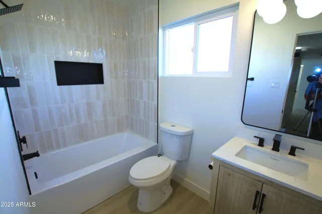 an empty room with a window and a ceiling fan