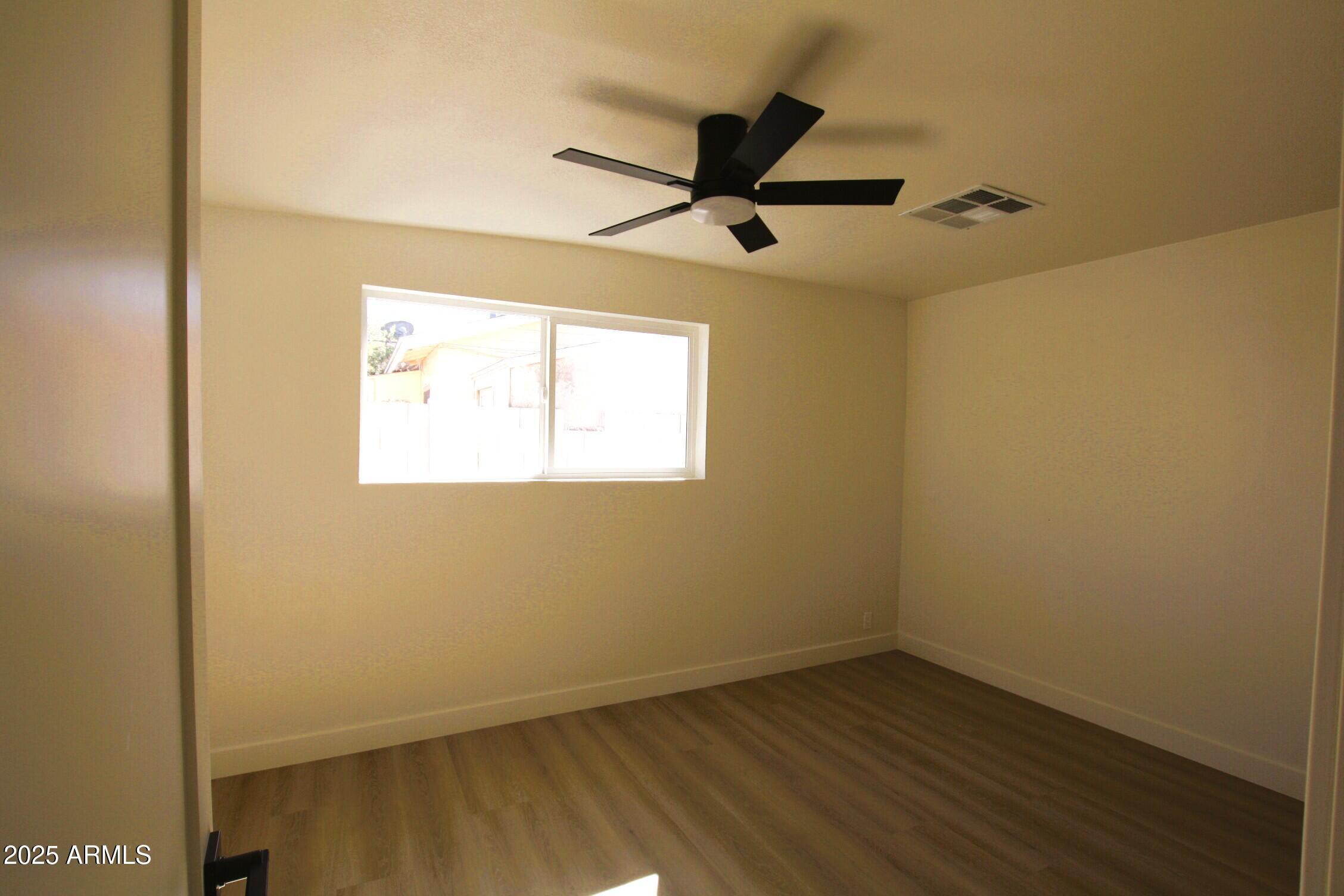 443 North Sycamore Mesa, AZ 85201 - Photo 20 of 33 an empty room with a window and a ceiling fan