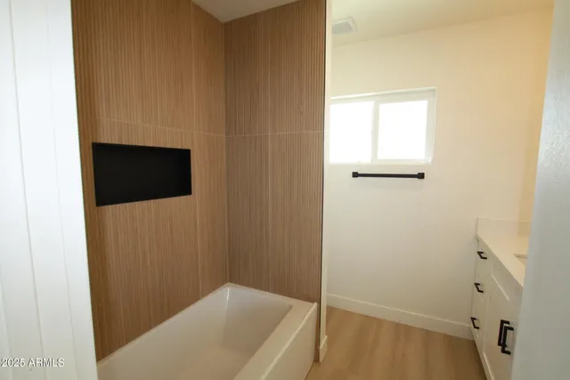 a bathroom with a shower and a tub