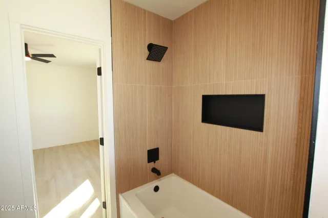 a bathroom with a tub and shower
