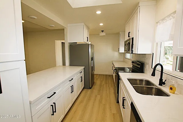 a kitchen with cabinets and stainless steel appliances