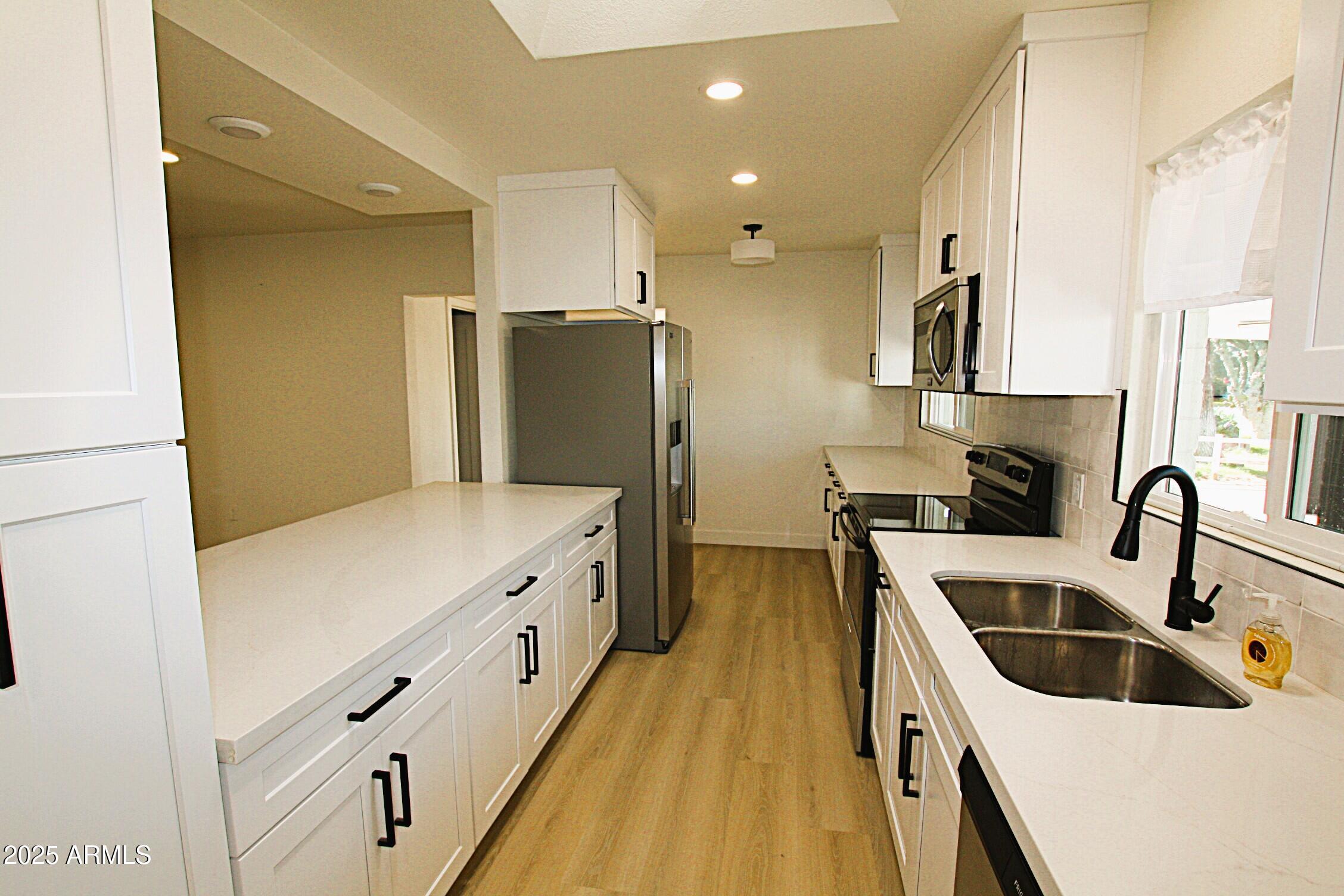 443 North Sycamore Mesa, AZ 85201 - Photo 5 of 33 a kitchen with cabinets and stainless steel appliances