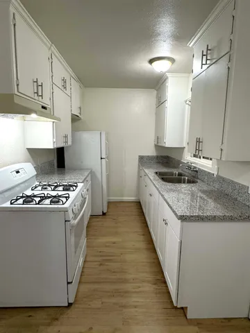 a kitchen with stainless steel appliances granite countertop a stove and a sink