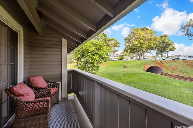 a view of a two chairs in the balcony