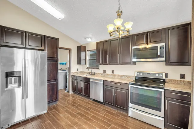 a kitchen with a sink stove and refrigerator
