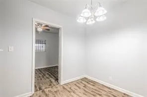 a view of a chandelier fan and wooden floor