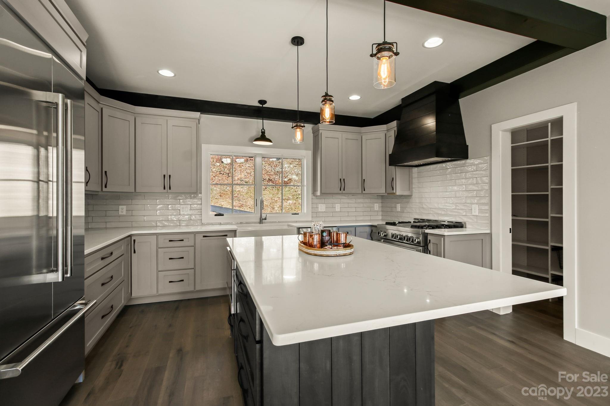 1736 Twin Rivers Drive Boone, NC 28607 - Photo 11 of 48 a kitchen with a sink a stove and cabinets