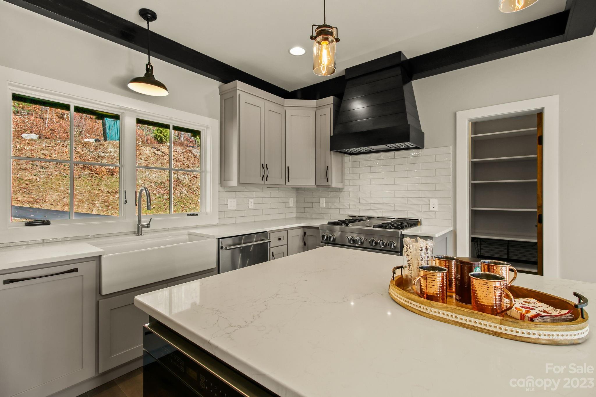 1736 Twin Rivers Drive Boone, NC 28607 - Photo 14 of 48 a kitchen with a sink a stove and microwave