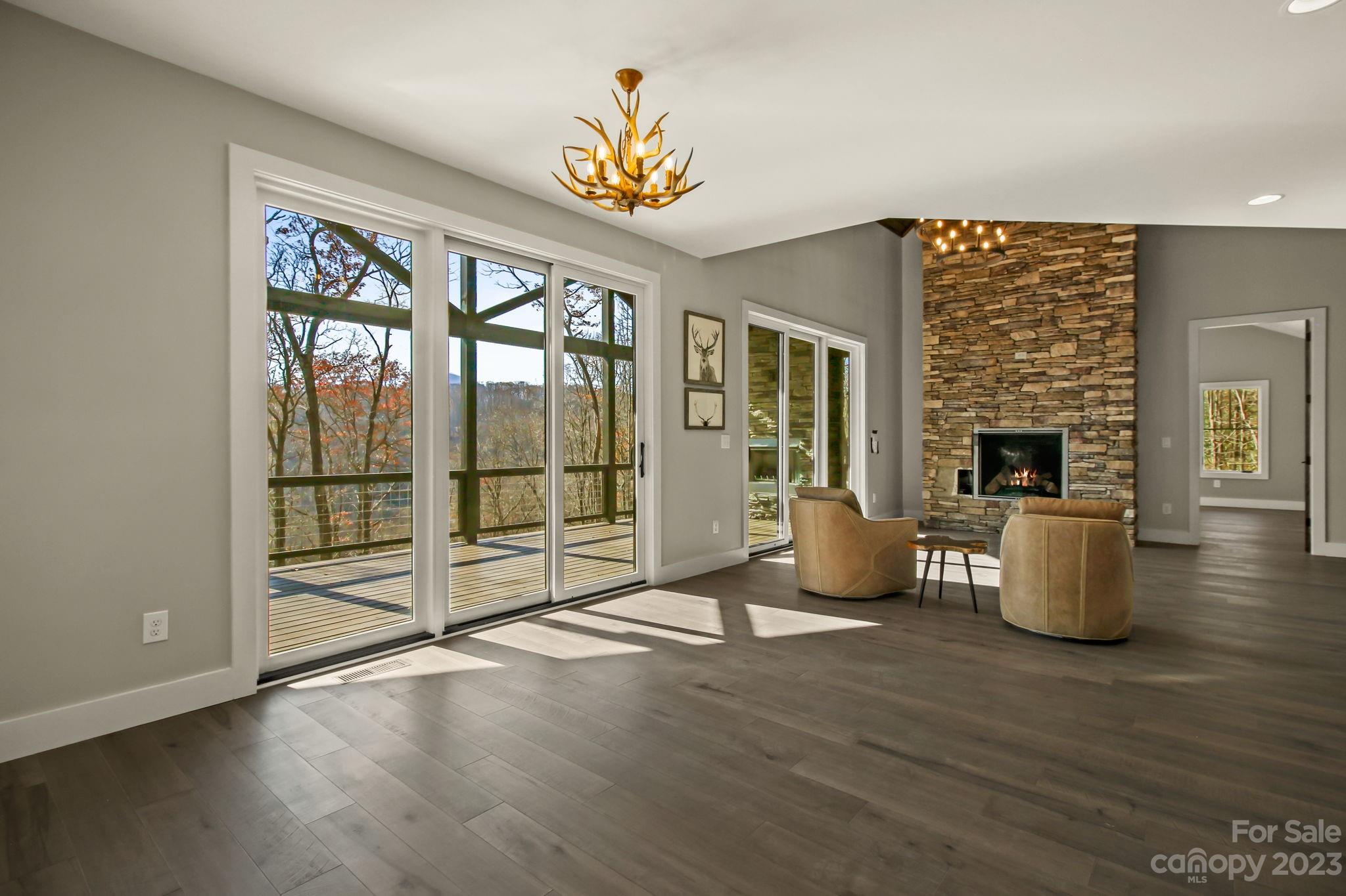 1736 Twin Rivers Drive Boone, NC 28607 - Photo 15 of 48 a view of an empty room with wooden floor and a window