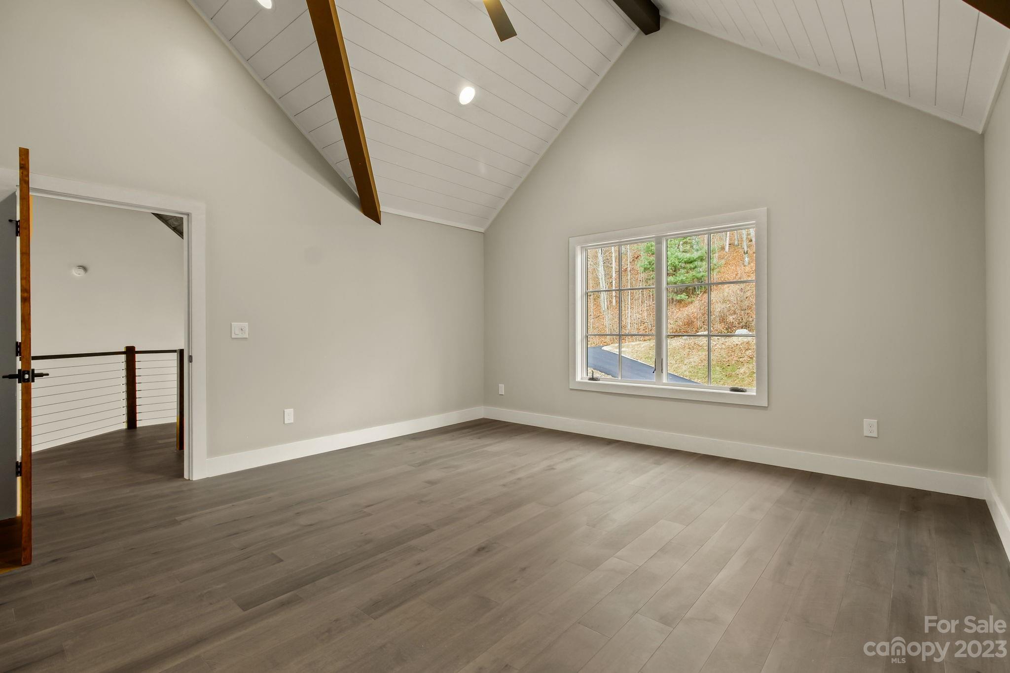1736 Twin Rivers Drive Boone, NC 28607 - Photo 27 of 48 an empty room with wooden floor and windows