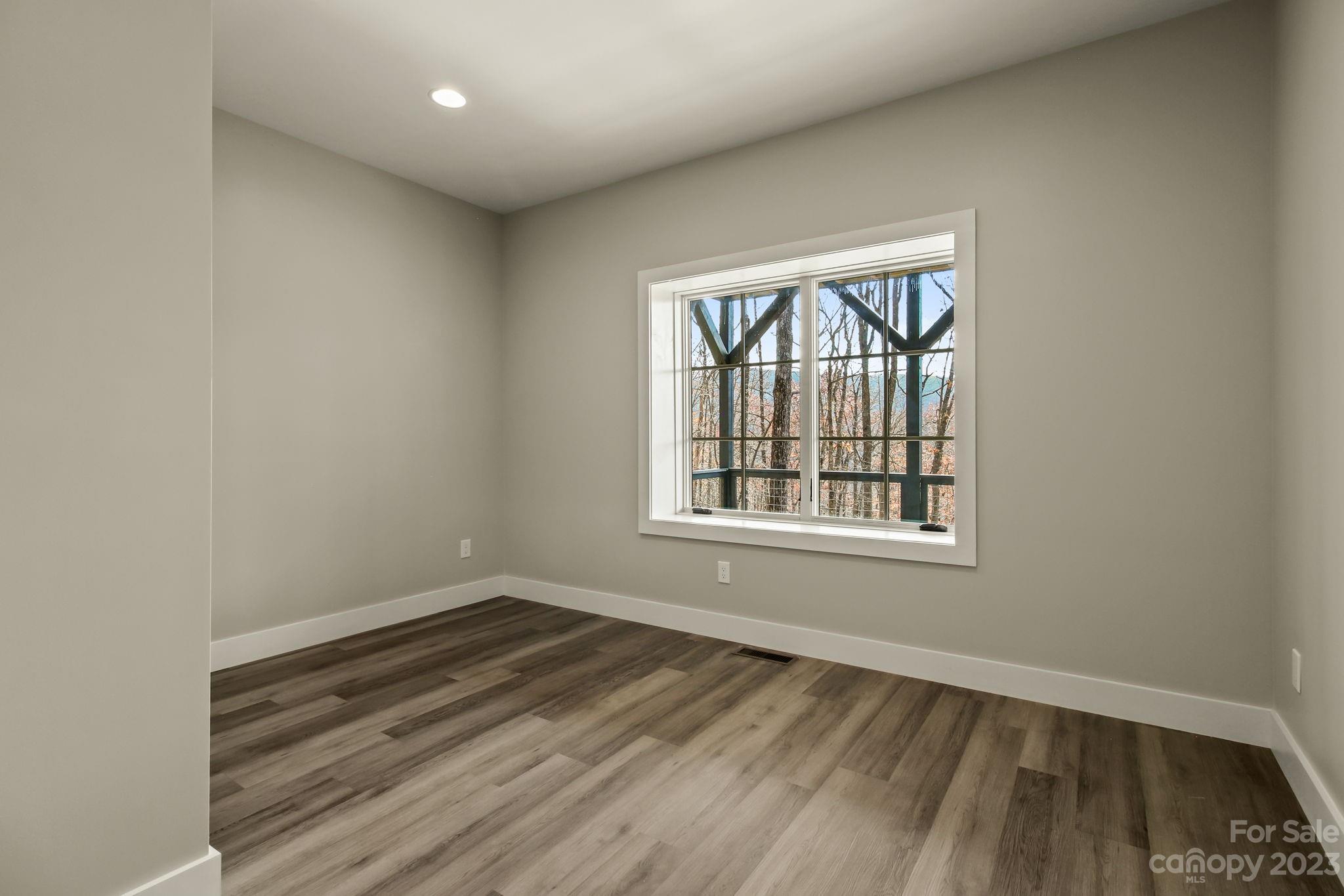 1736 Twin Rivers Drive Boone, NC 28607 - Photo 35 of 48 an empty room with wooden floor and windows