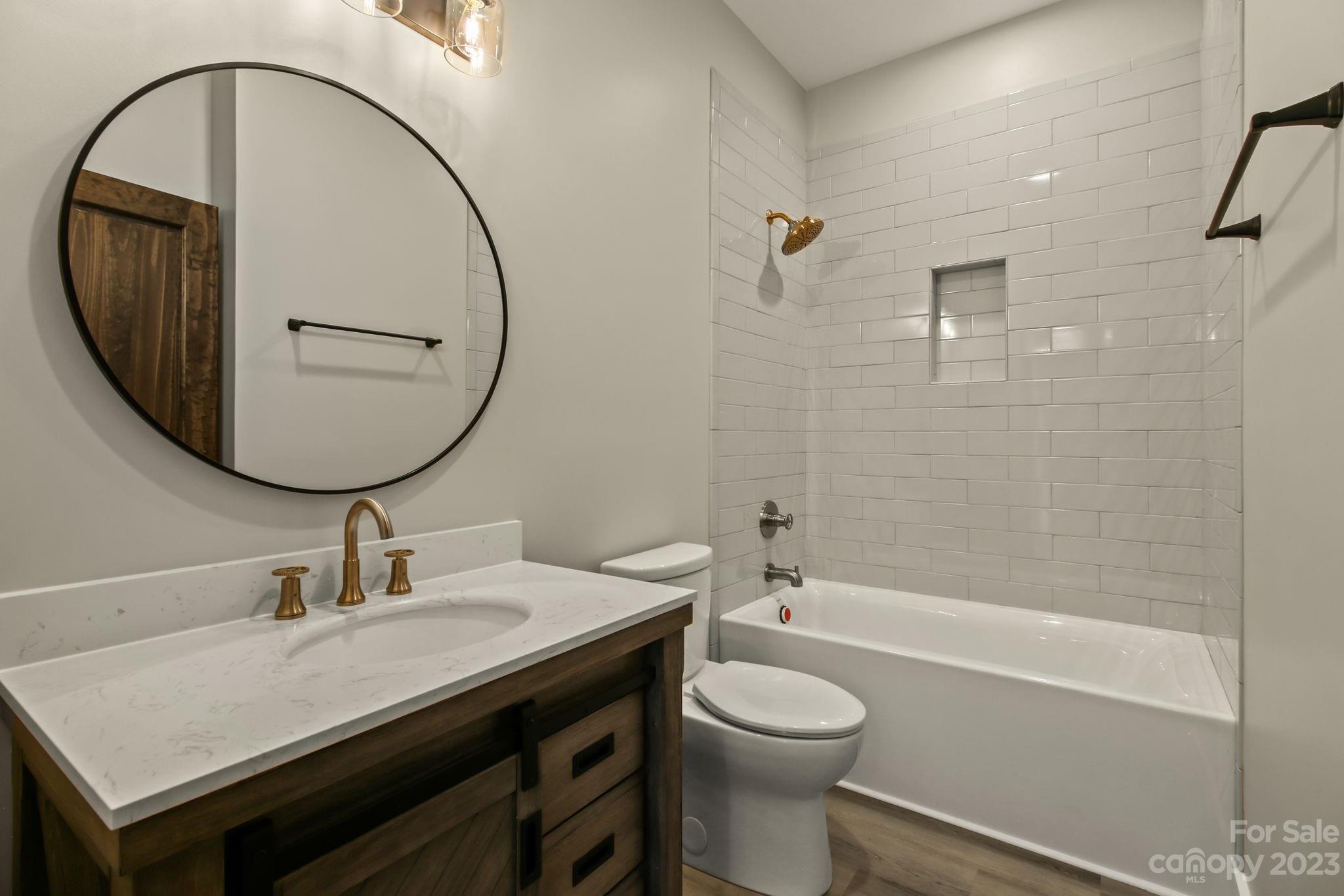 1736 Twin Rivers Drive Boone, NC 28607 - Photo 36 of 48 a bathroom with a sink a toilet and a mirror
