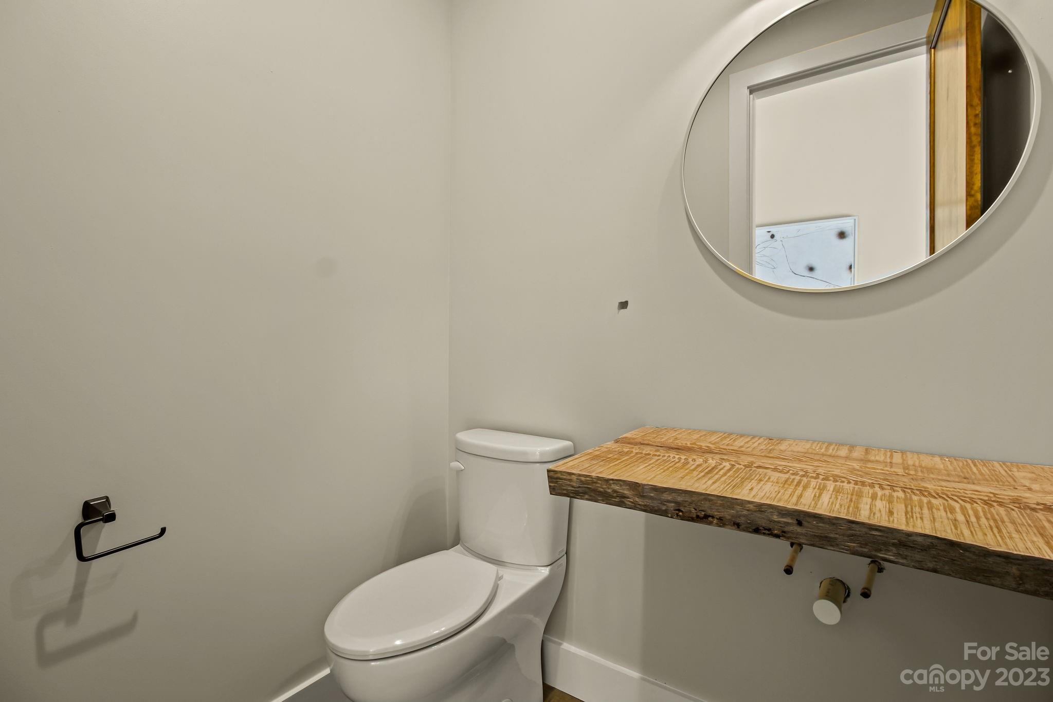 1736 Twin Rivers Drive Boone, NC 28607 - Photo 39 of 48 a white toilet sitting next to a bathroom sink