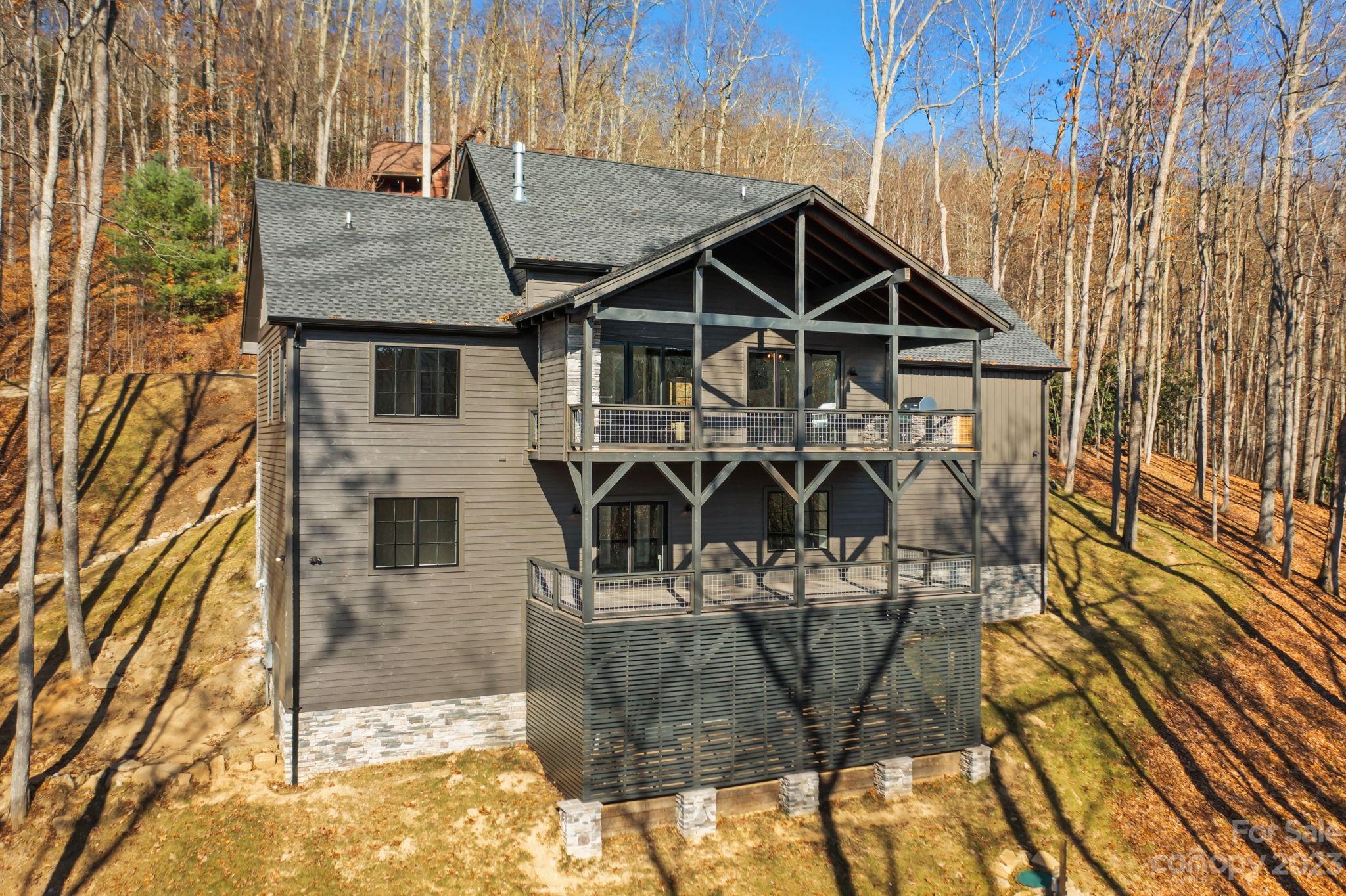 1736 Twin Rivers Drive Boone, NC 28607 - Photo 41 of 48 a view of a house with wooden deck and backyard