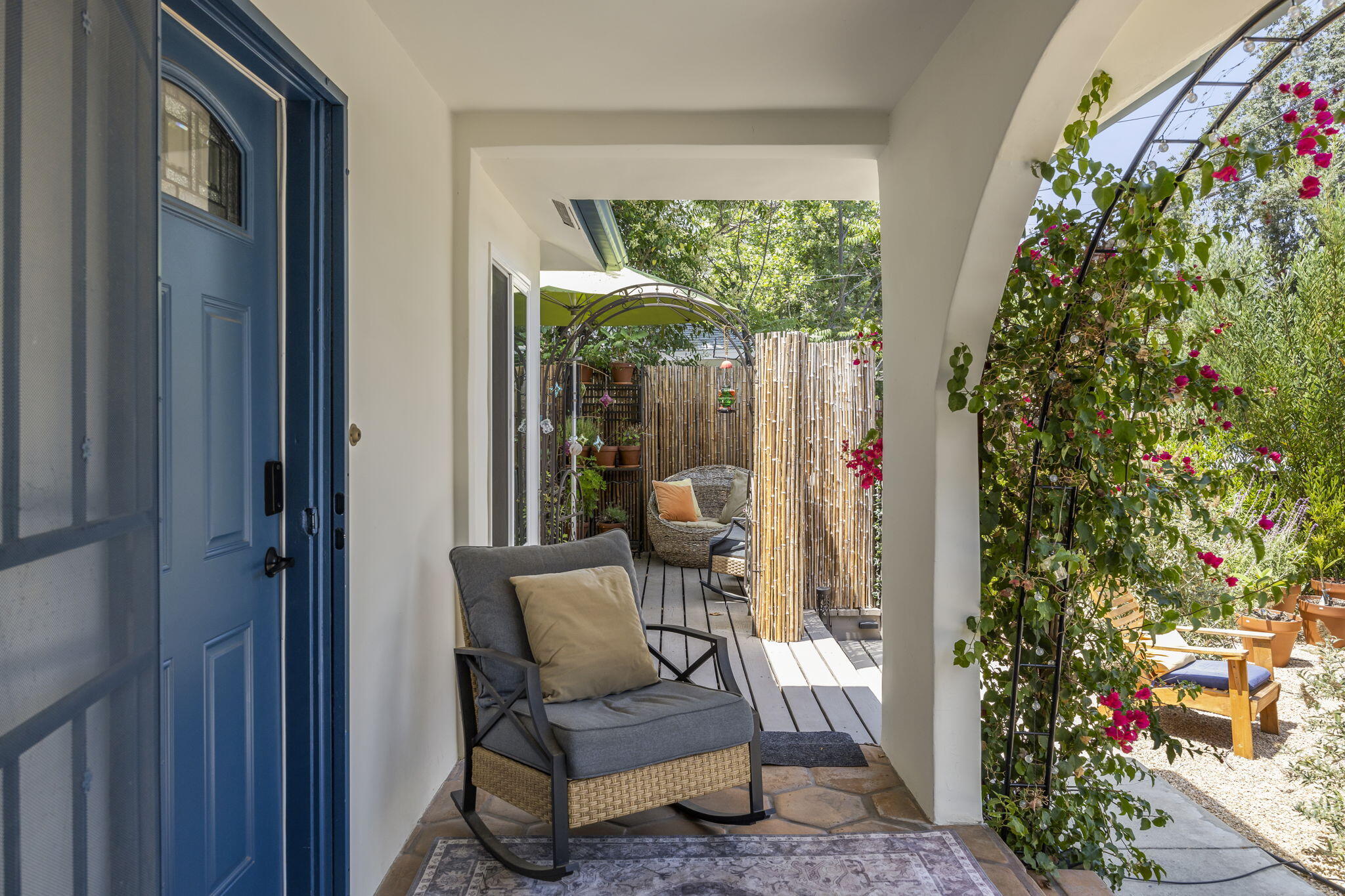 301 Park Road Ojai, CA 93023 - Photo 7 of 38 a view of a porch with a table and chairs and potted plants