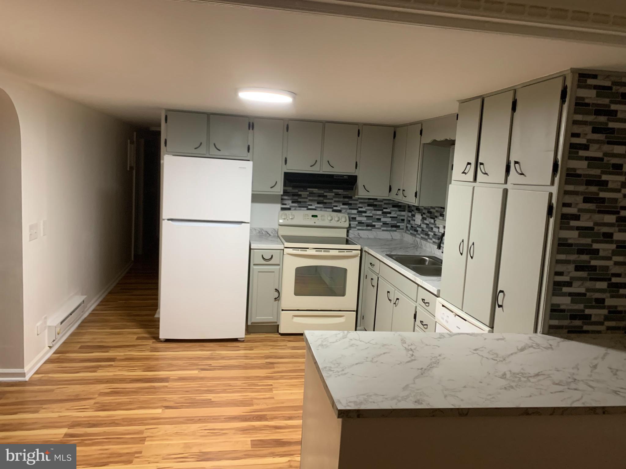720 Berry Road, Unit 95 Wilmington, DE 19810 - Photo 11 of 12 a kitchen with a stove a refrigerator and a sink