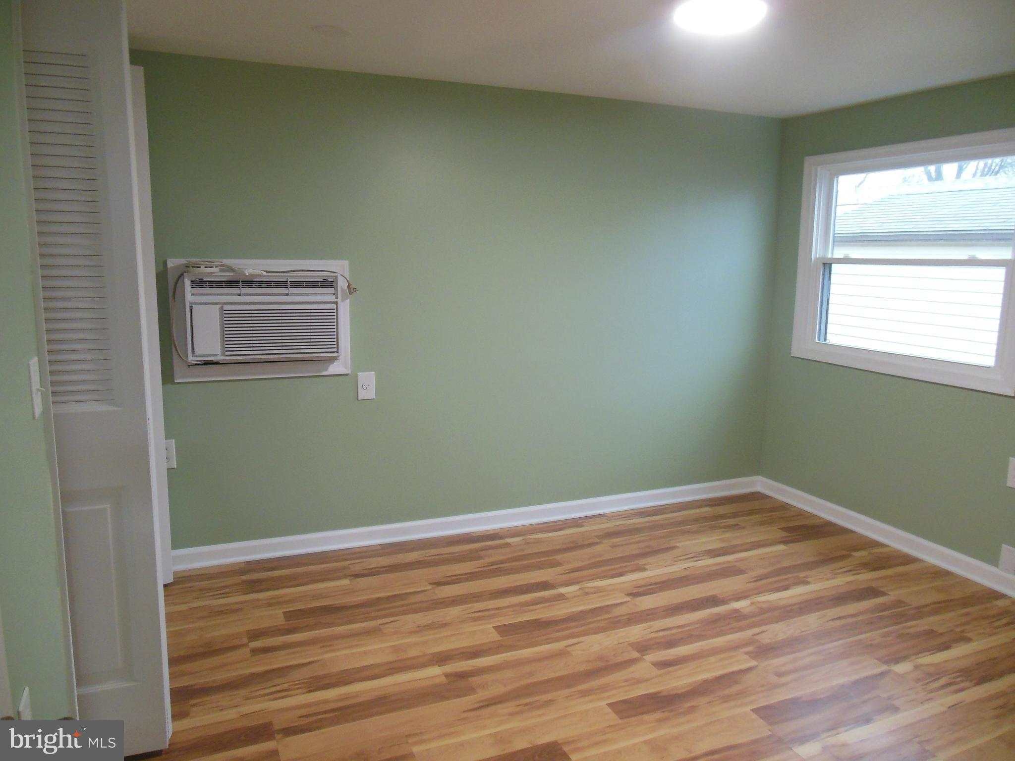 720 Berry Road, Unit 95 Wilmington, DE 19810 - Photo 7 of 12 an empty room with wooden floor and windows