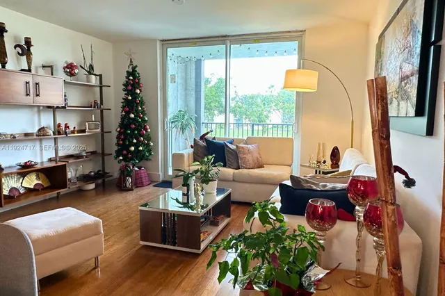 a living room with furniture fireplace and a large window