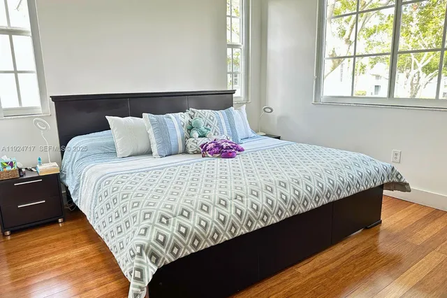 a large bed sitting in a bedroom next to a window