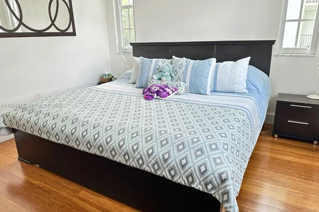 a bed sitting in a bedroom next to a lamp