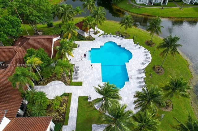 an aerial view of a house with a yard and potted plants
