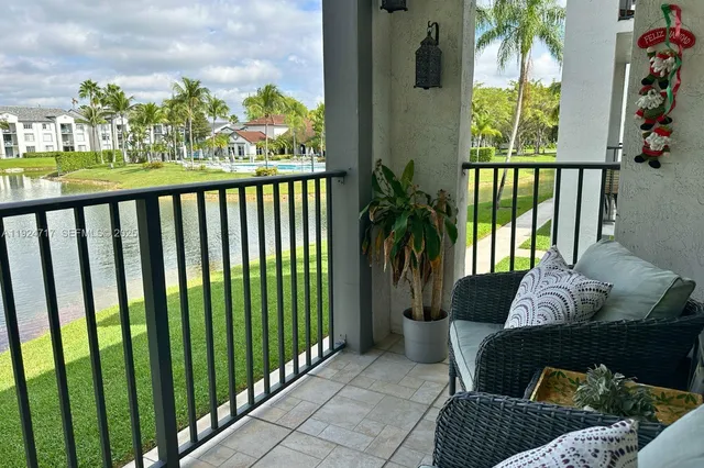 a balcony with furniture and a potted plant