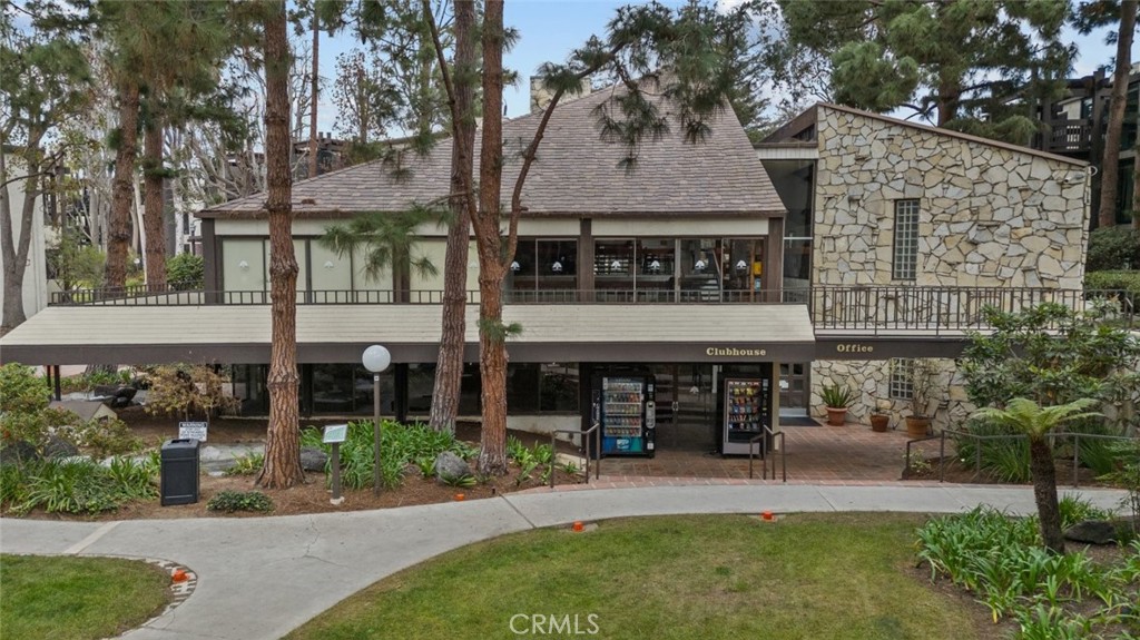 a view of a building with a garden and sitting area