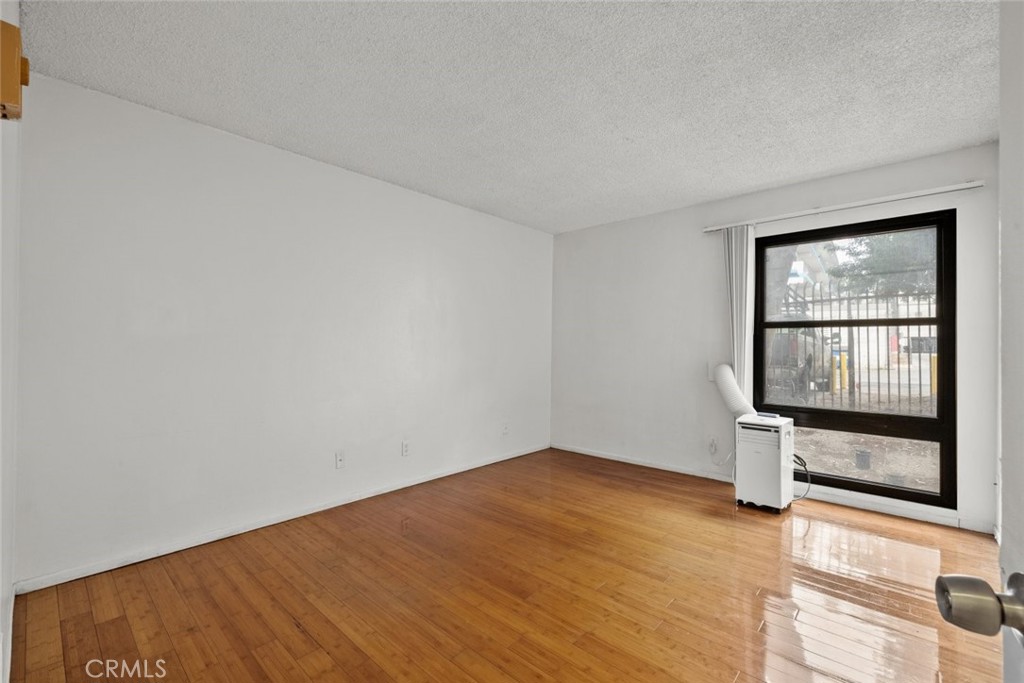 7740 Redlands Street, Unit G1097 Playa del Rey, CA 90293 - Photo 12 of 37 wooden floor in an empty room with a window