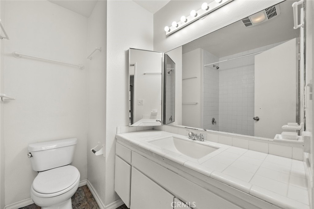 7740 Redlands Street, Unit G1097 Playa del Rey, CA 90293 - Photo 14 of 37 a bathroom with a sink a toilet and a mirror