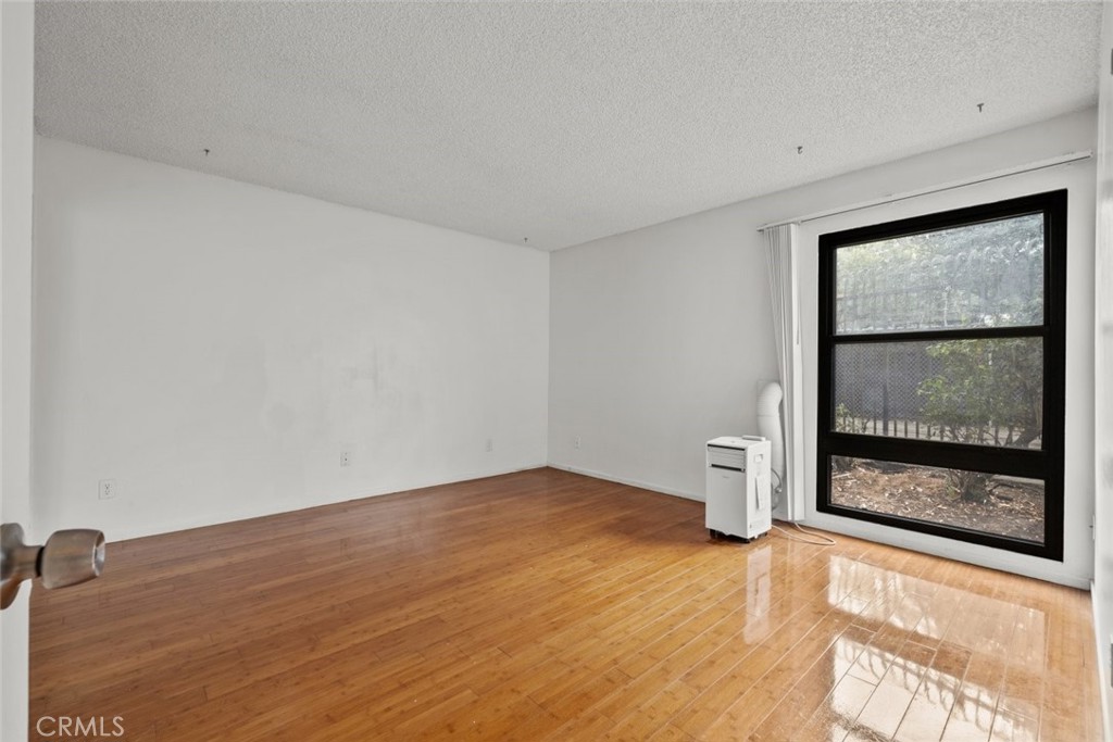 7740 Redlands Street, Unit G1097 Playa del Rey, CA 90293 - Photo 20 of 37 wooden floor in an empty room with a window