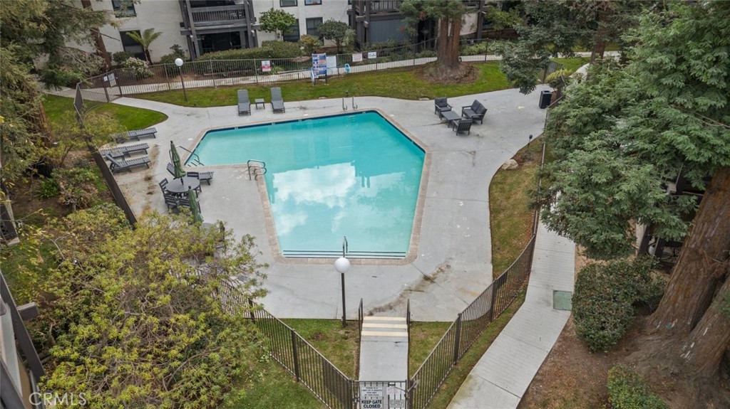 7740 Redlands Street, Unit G1097 Playa del Rey, CA 90293 - Photo 4 of 37 a view of a swimming pool with a patio and plants