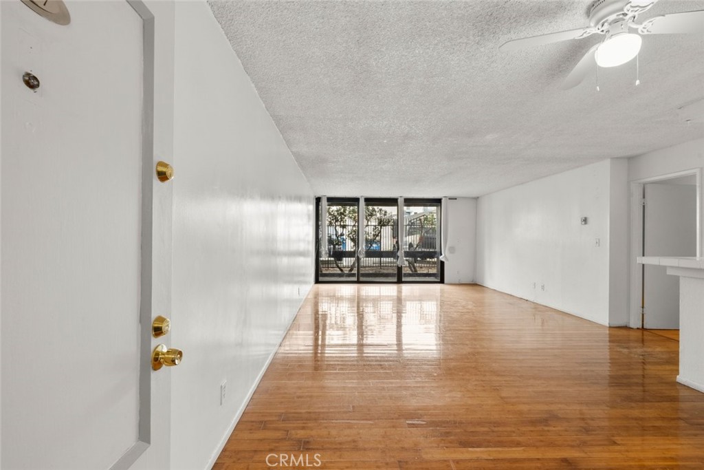 7740 Redlands Street, Unit G1097 Playa del Rey, CA 90293 - Photo 6 of 37 a view of an empty room with window and wooden floor