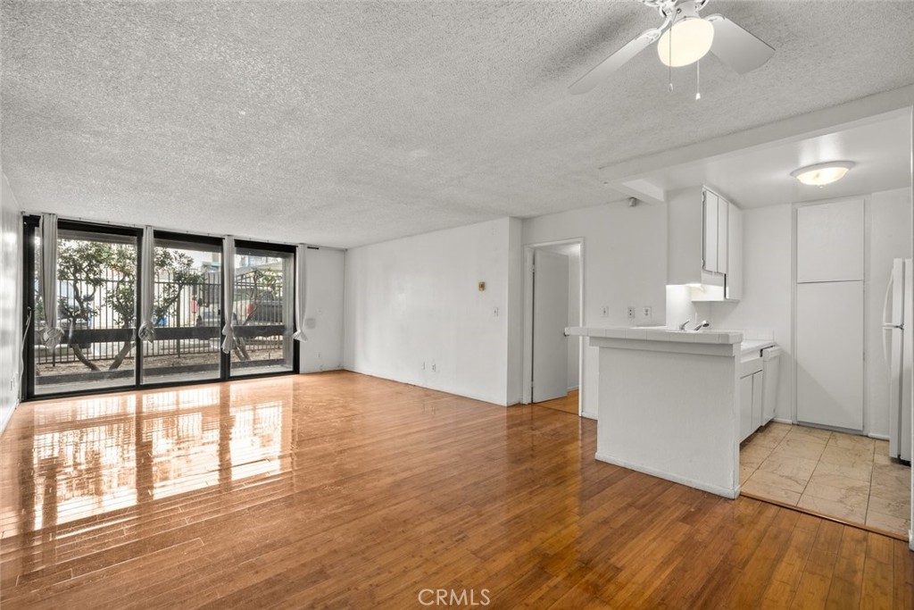 7740 Redlands Street, Unit G1097 Playa del Rey, CA 90293 - Photo 8 of 37 a view of empty room with wooden floor and fan