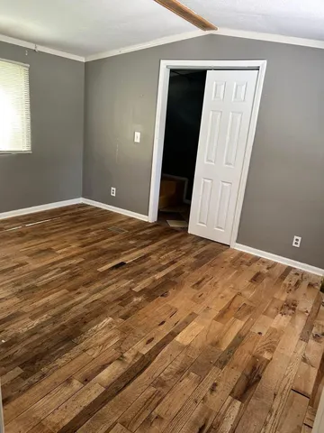 a view of a closet area with wooden floor