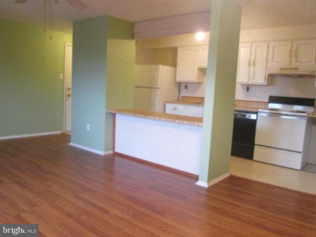 550 Heather Ridge Drive, Unit M Frederick, MD 21702 - Photo 5 of 9 a view of a kitchen with a fridge and wooden floor