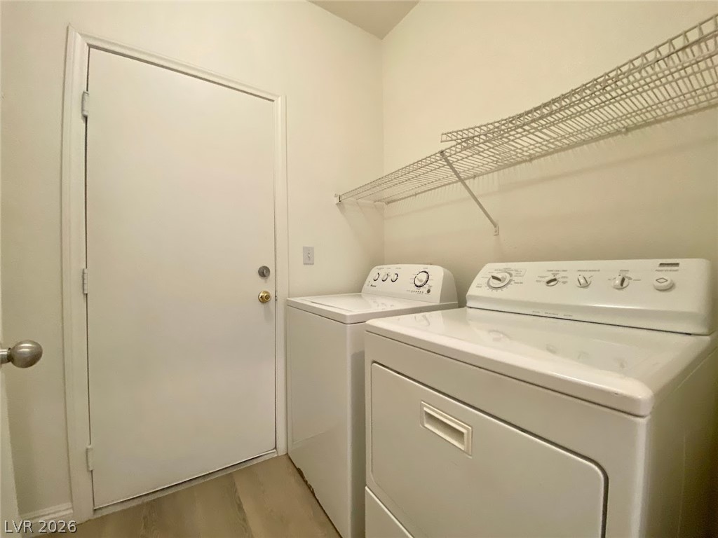 4033 Spring Line Street North Las Vegas, NV 89032 - Photo 11 of 30 This dedicated laundry space features practical storage and essential appliances for daily chores.