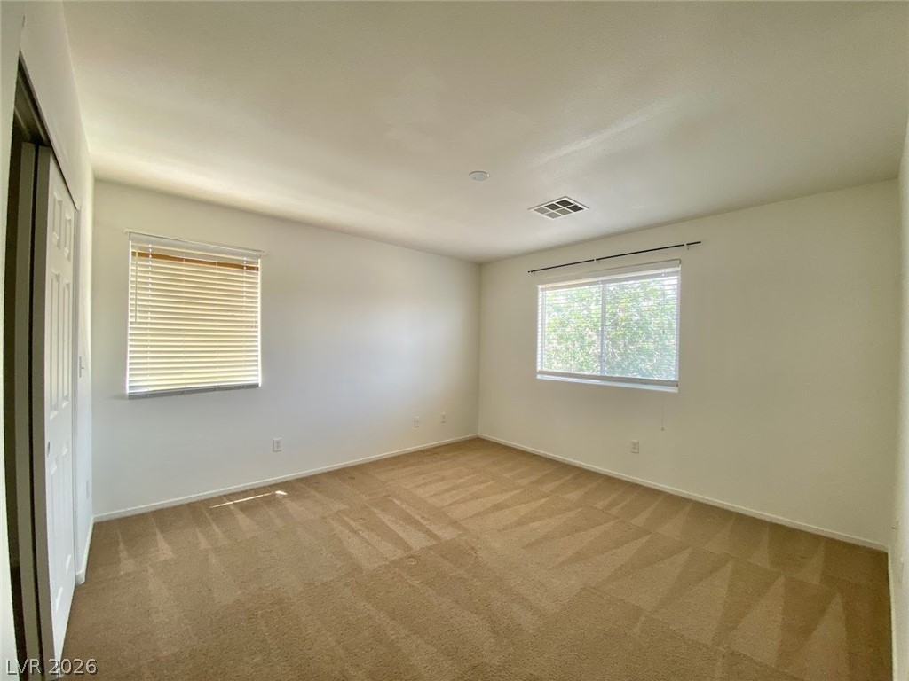 4033 Spring Line Street North Las Vegas, NV 89032 - Photo 13 of 30 This spacious room features ample natural light, creating a bright and inviting atmosphere.