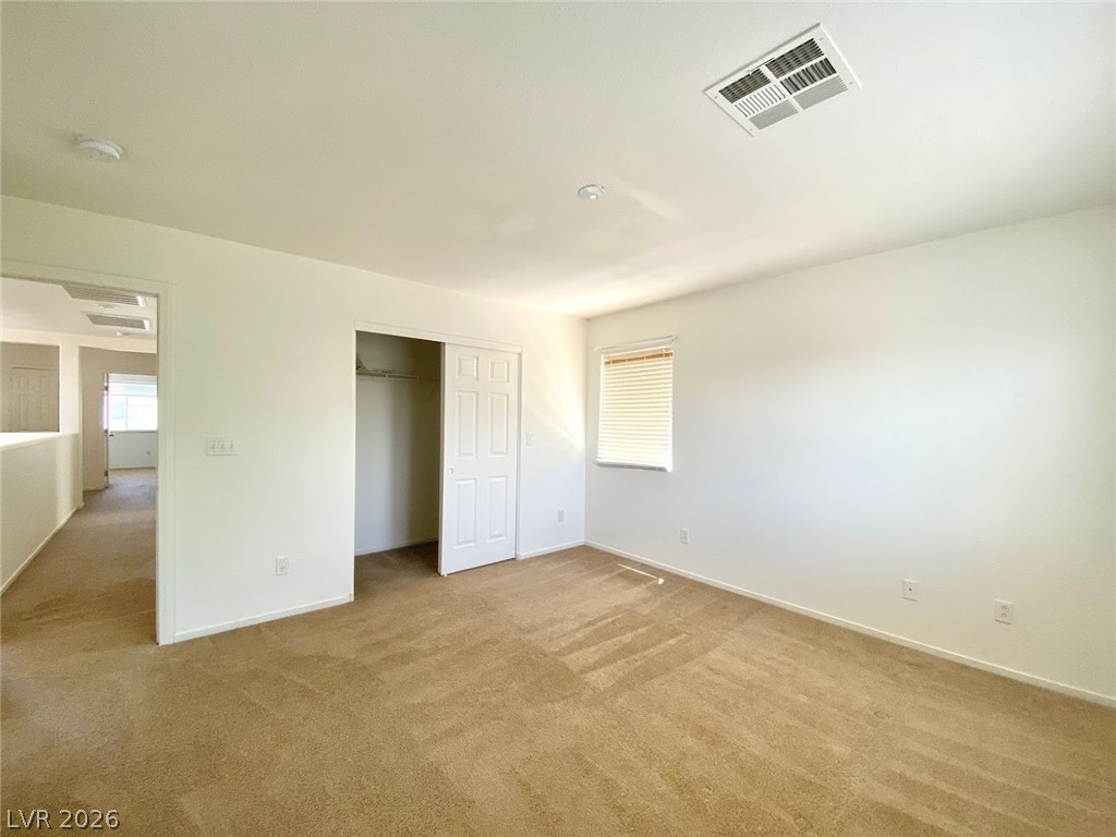 4033 Spring Line Street North Las Vegas, NV 89032 - Photo 14 of 30 This spacious room features neutral tones and ample light, offering a versatile living space.