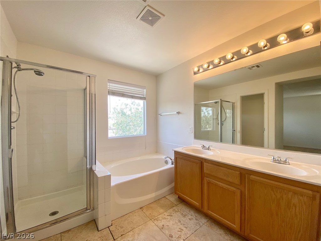 4033 Spring Line Street North Las Vegas, NV 89032 - Photo 16 of 30 This bright bathroom offers a dual vanity, separate shower, and a soaking tub.
