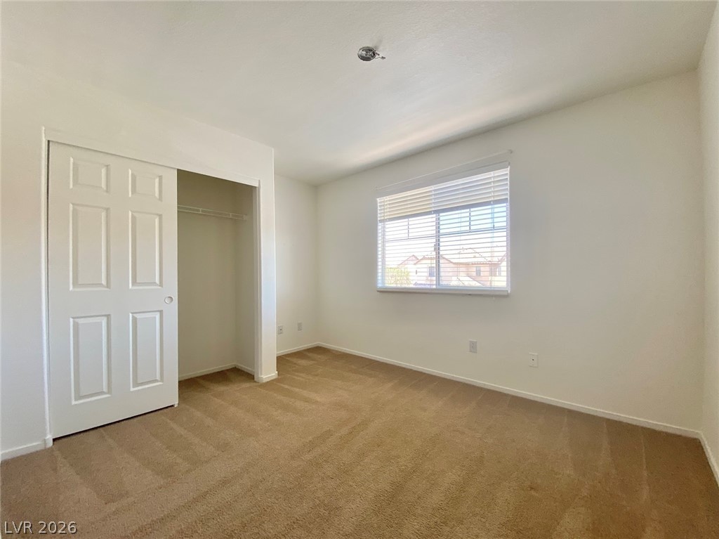 4033 Spring Line Street North Las Vegas, NV 89032 - Photo 22 of 30 This spacious bedroom offers ample natural light and a generous closet.