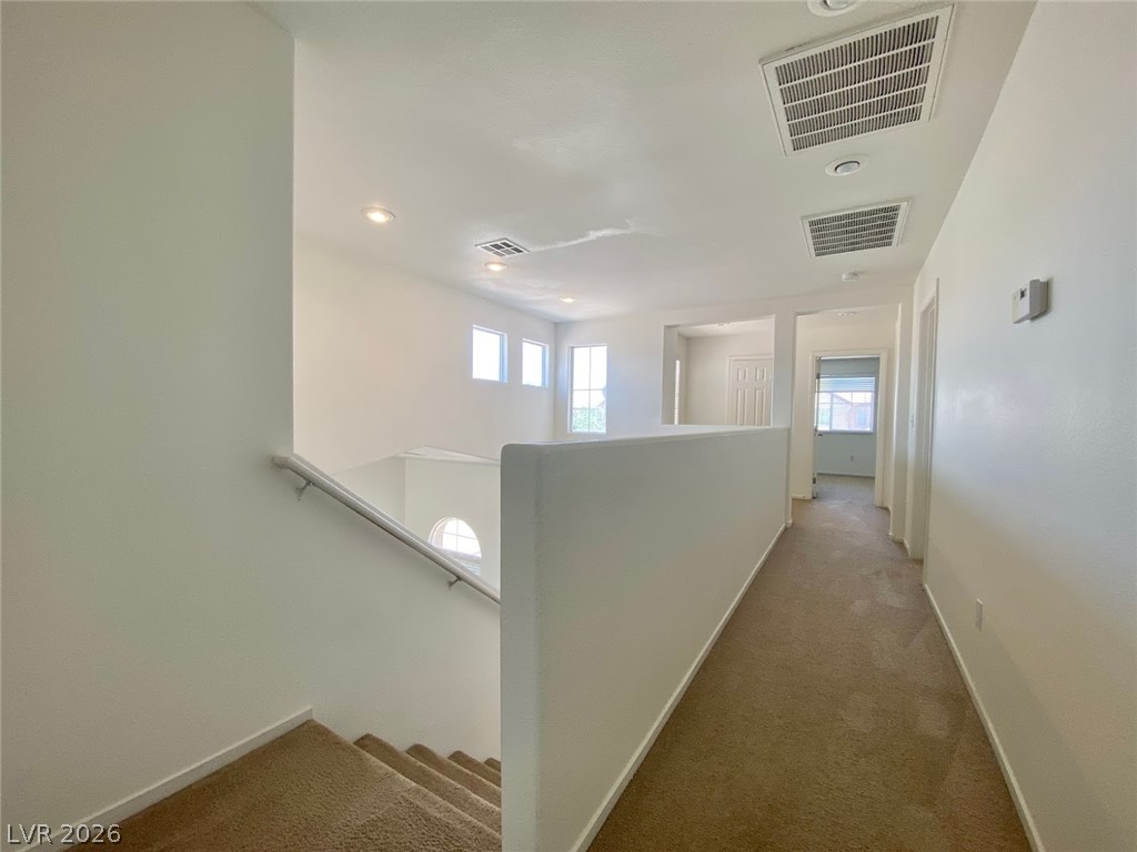 4033 Spring Line Street North Las Vegas, NV 89032 - Photo 25 of 30 This spacious interior features a bright hallway with recessed lighting, offering seamless flow throughout the home.