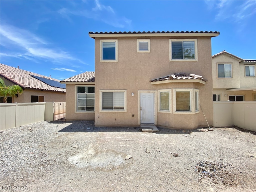 4033 Spring Line Street North Las Vegas, NV 89032 - Photo 29 of 30 This property features a tiled roof and bay window, with a fenced yard offering privacy.