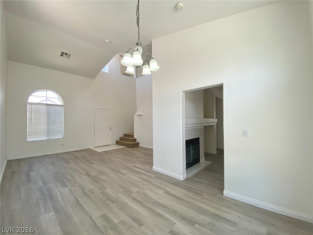 4033 Spring Line Street North Las Vegas, NV 89032 - Photo 3 of 30 This bright living area features high ceilings, a fireplace, and elegant flooring.