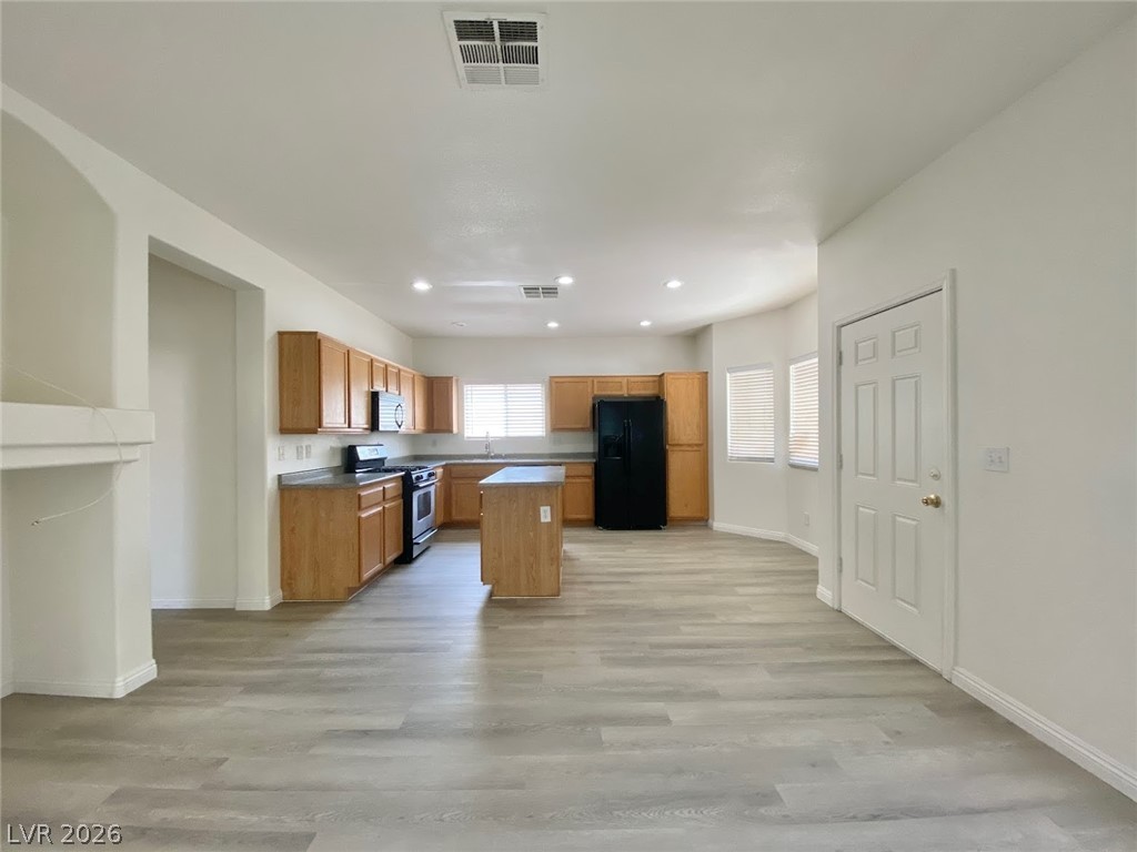 4033 Spring Line Street North Las Vegas, NV 89032 - Photo 9 of 30 This spacious kitchen and living area features modern amenities and abundant natural light.
