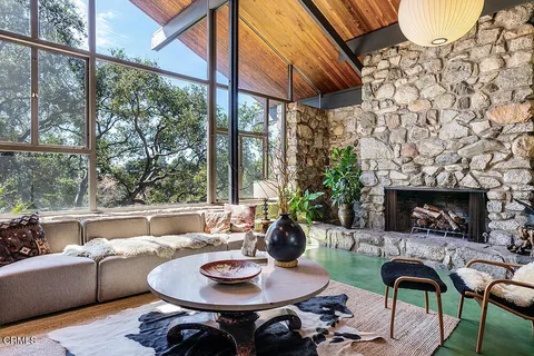 a living room with fireplace furniture and a fireplace