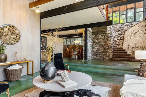 a dining room with furniture and a floor to ceiling window