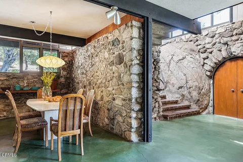 a dining room with furniture and a chandelier