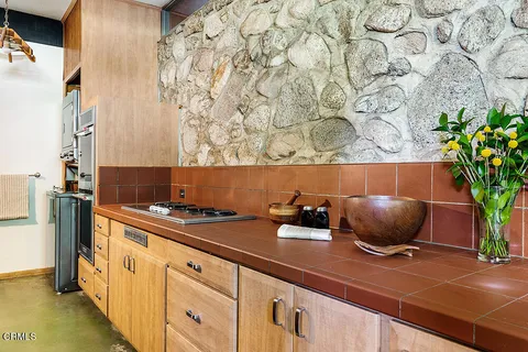 a kitchen with a stove and cabinets